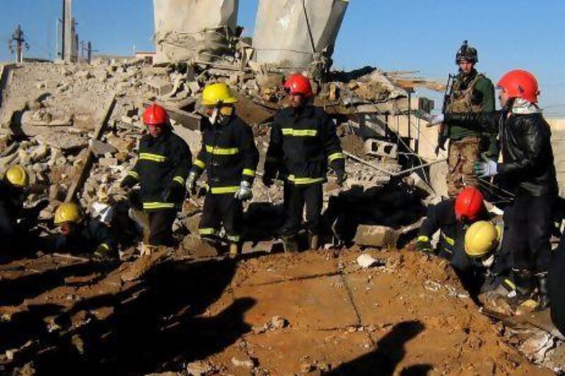 Fire fighters look for survivors at the local headquarters of the Kurdistan Democratic Party after a bomb attack in Kirkuk.