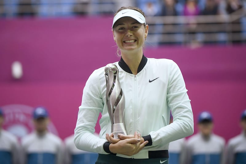 Maria Sharapova of Russia holds her trophy after winning her women's singles final match against Aryna Sabalenka of Belarus at the Tianjin Open tennis tournament in Tianjin on October 15, 2017. / AFP PHOTO / WANG Zhao