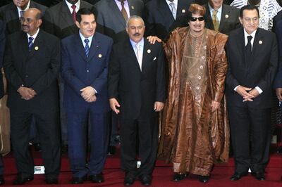 (FILES) In this file photo taken on October 10, 2010, (L to R) Tunisian President Zine El Abidine Ben Ali, Yemeni President Ali Abdullah Saleh, Libyan leader Moammar Kadhafi, and Egyptian President Hosni Mubarak pose for a group picture with other African and Arab presidents in the second Afro-Arab Joint Summit in Libya's coastal city of Sirte. Ten years ago, a wildfire of revolts in the Arab world touched off an unlikely series of events that swelled, then dashed many hopes, and irrevocably changed the region. From the quickfire collapse of seemingly invincible regimes to the rise and fall of a jihadist caliphate in its heart, the Middle East hurtled through the century's second decade in a state of relentless upheaval. The chain of uprisings that shook the region from late 2010 and was soon dubbed the "Arab Spring" led to disparate long-term outcomes, with many countries looking worse off. The popular protests that erupted in Tunisia, Egypt, Libya and Yemen a decade ago were followed by disappointing reforms at best, dictatorial backlash or all-out conflict at worst. / AFP / KHALED DESOUKI
