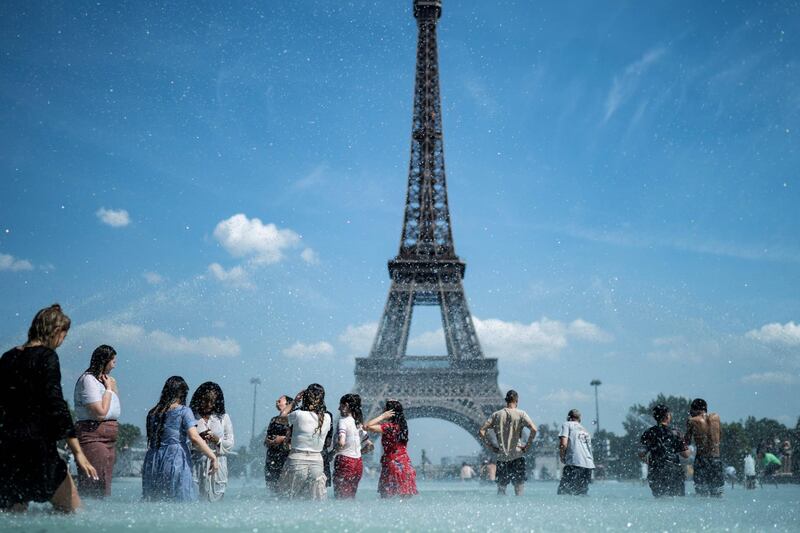 People cool themselves down in the fountain of the Trocadero esplanade in Paris with the Eiffel Tower on the background. Forecasters say Europeans will feel sizzling heat this week with temperatures soaring as high as 40 degrees Celsius (104 degrees Fahrenheit) in an "unprecedented" June heatwave hitting much of Western Europe. AFP
