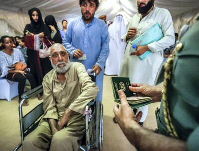 Abu Dhabi, U.A.E., August 1, 2018.
Amnesty seekers at the Shahama Police Centre.  (on wheelchair) Zahir Janan Abdul Jabar- 60, is given priority by immigration officials.
Victor Besa / The National
Section:  NA
Reporter:  Haneen Dajani