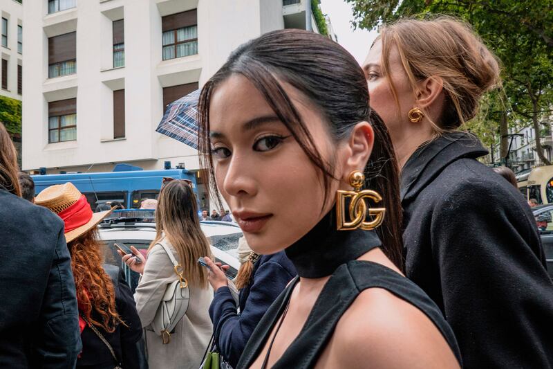 A guest, wearing Dolce & Gabbana logo earrings, ahead of the show. LaPresse via AP