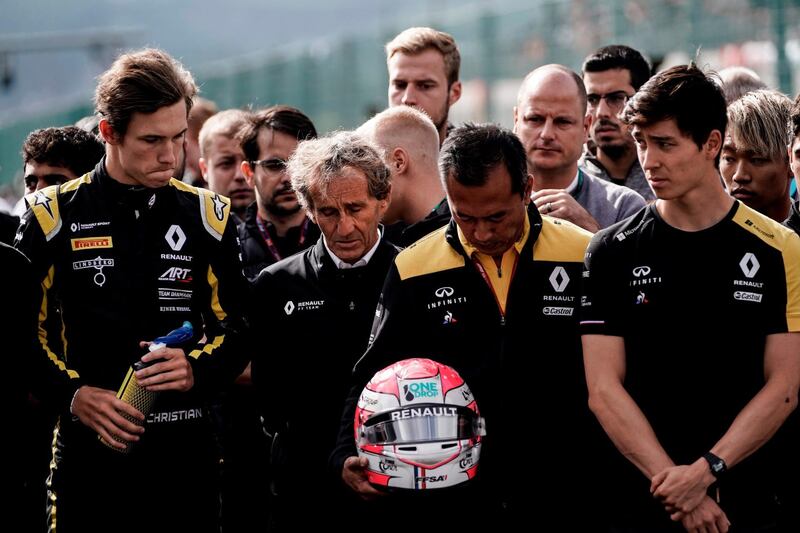 TOPSHOT - Retired French racing driver and Renault special advisor Alain Prost (2L) and Renault team members observe a minute's silence before the start of the race of Formula3 on September 1, 2019, at the Spa-Francorchamps circuit in Spa the day of the Belgian Formula One Grand Prix. French driver Anthoine Hubert, 22, was killed on August 31 in Spa in an accident during a Formula 2 race held on the sidelines of the F1 Grand Prix, according to organizers of the race. / AFP / Kenzo TRIBOUILLARD
