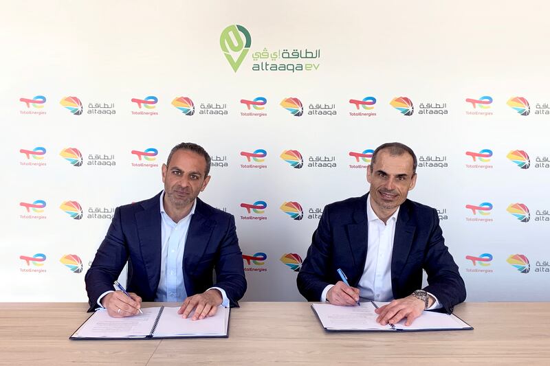 Majid Zahid and Pierre Clasquin sign the preliminary agreement between Altaaqa and TotalEnergies to set up electric vehicle charging stations. Photo: TotalEnergies