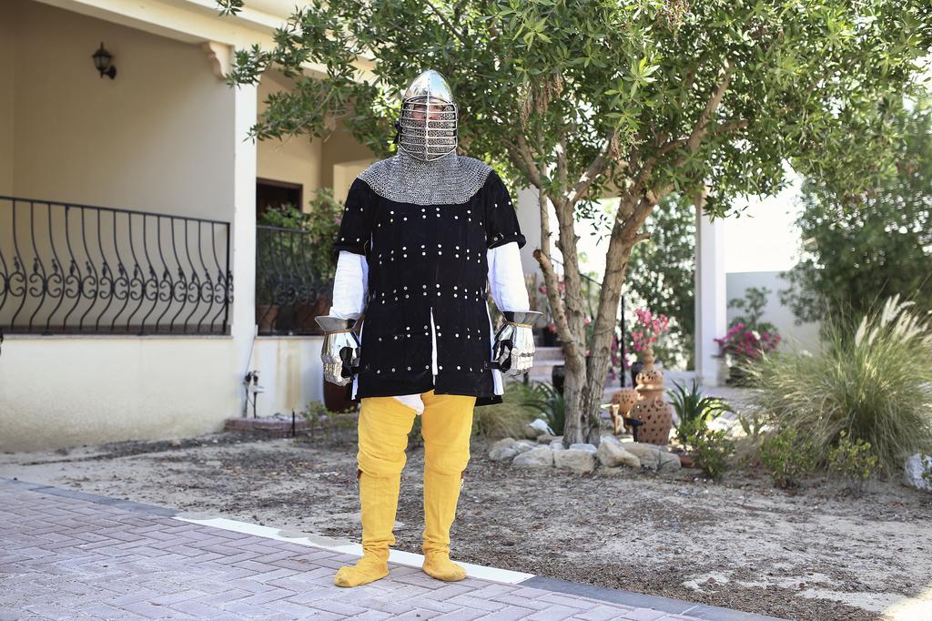 Mike Labney aka Earik is photographed wearing a late 14th century  coat of plates and a  bascinet, a Medieval European open-faced military helmet, in Abu Dhabi.