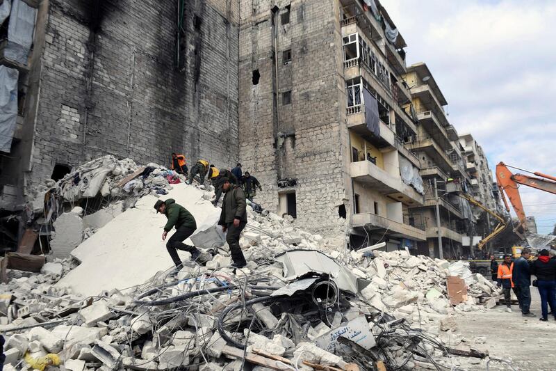 In this photo released by the Syrian official news agency SANA, people inspect a destroyed building where, according to SANA, the five-story building collapsed early Saturday, Feb. 2, 2019,  killing most of those who were inside and only one person was rescued alive, in the northern city of Aleppo, Syria.  SANA said that a building damaged during years of war in the northern city of Aleppo has collapsed killing 11 people. (SANA via AP)