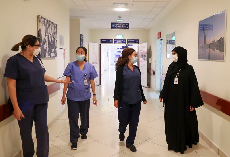 Arwa Salem Al Menhali, far right, assistant director of nursing, with, left to right, charge nurse Tan Cheng Nee, staff nurse Yvette Prieto and senior charge nurse Ramza El Chaer at Corniche Hospital, Abu Dhabi. Khushnum Bhandari / The National