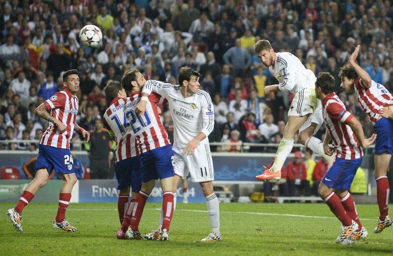 Real Madrid defender Sergio Ramos, in air, scores the equaliser after the 90th minute in injury time during the Champions League final on Saturday. Miguel Riopa / AFP / May 24, 2014