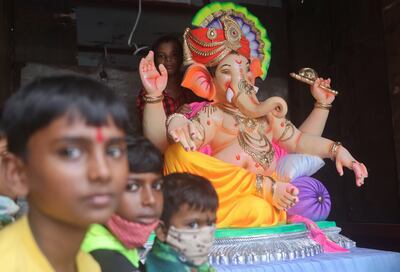 Children sit next to an idol of the Hindu god Ganesh inside a truck at the start of the 10-day Ganesh Chaturthi festival in Mumbai. Reuters
