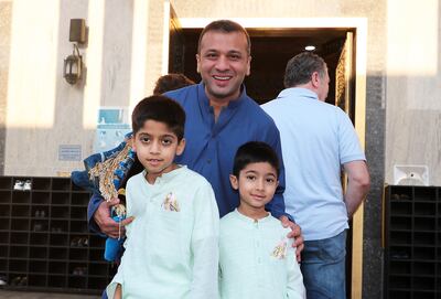 Bilal Abrahim with his sons Rayan and Yousef after Eid Al Fitr prayers at Al Farooq Omar Bin Al Khattab Mosque in Dubai. Pawan Singh / The National