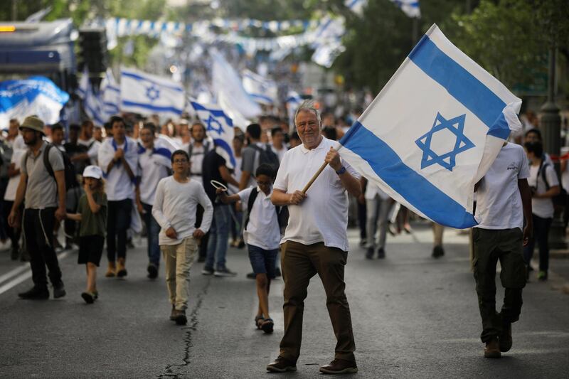 A man waves an Israeli flag during a parade marking 'Jerusalem Day', amid high Israeli-Palestinian tension, in Jerusalem. Reuters