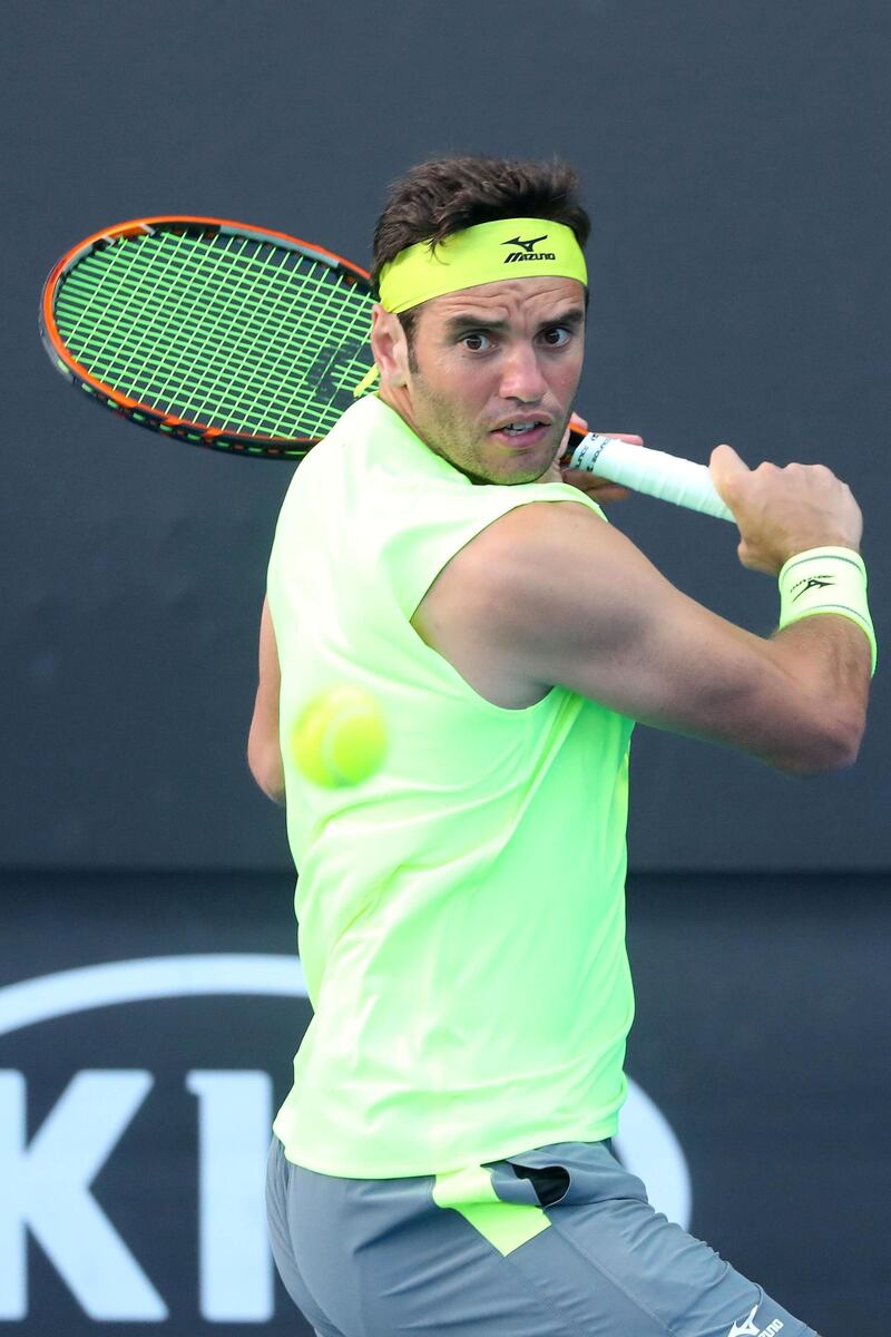 MELBOURNE, AUSTRALIA - JANUARY 15:  Malek Jaziri of Tunisia plays a backhand in his first round match against Salvatore Caruso of Italy on day one of the 2018 Australian Open at Melbourne Park on January 15, 2018 in Melbourne, Australia.  (Photo by Pat Scala/Getty Images)