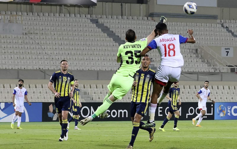 Pakhtakor's goalkeeper Sanjar Kuvvatov battles for the ball with Sharjah's defender Abdullah Ghanem. AFP