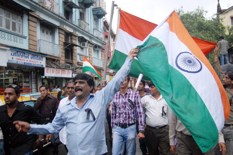 epa02826249 Indian people carry Indian flags as they participate in a peace march at the blast site at Opera House to pay homage to the bomb blast victims in Mumbai, India, 16 July 2011. According to media reports, investigators were examining security camera footage for clues to the Mumbai triple bomb blasts that killed 17 people, and wounded 134 others. The blasts on 14 July hit the Zaveri Bazaar jewellery market and the Opera House business district in southern Mumbai and the crowded neighbourhood of Dadar in central Mumbai.  EPA/DIVYAKANT SOLANKI *** Local Caption ***  02826249.jpg