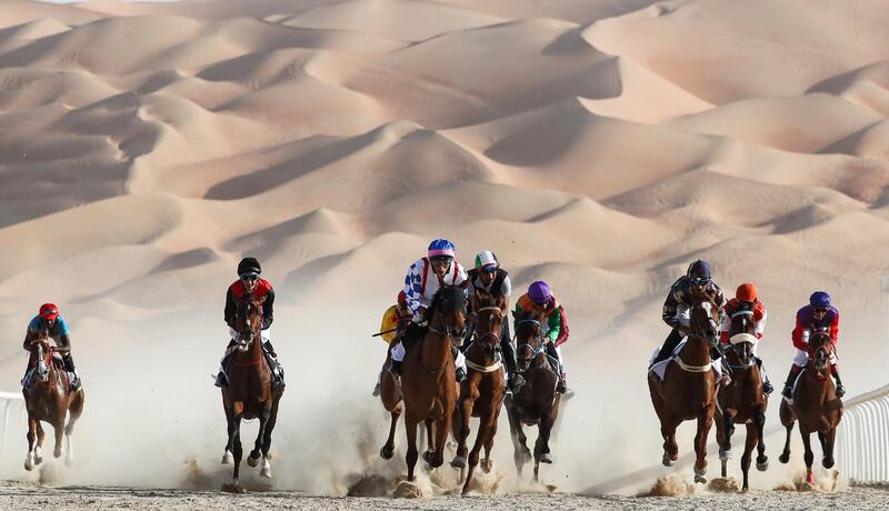 Jockeys compete in a race for purebred Arab horses during the Liwa 2019 Moreeb Dune Festival in the Liwa desert.  AFP