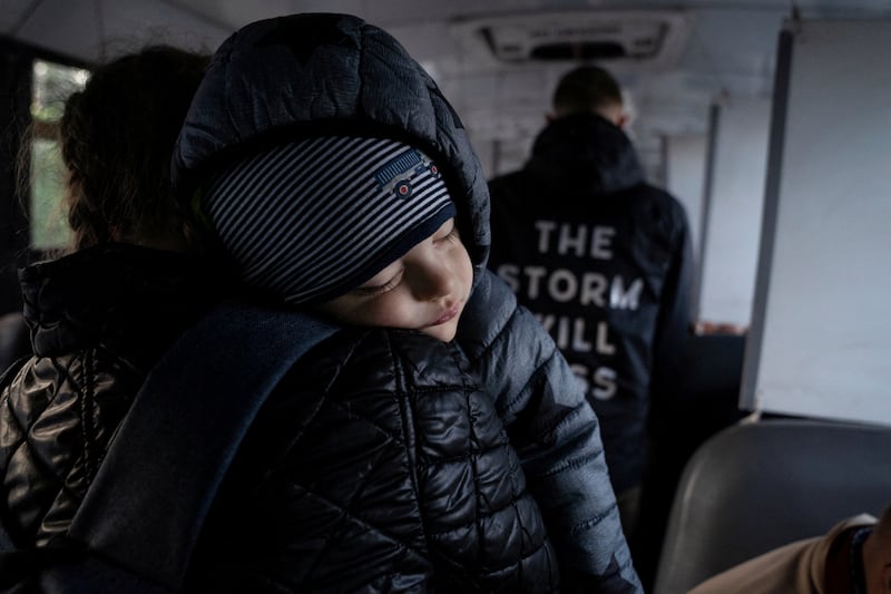 A Ukrainian child seeking asylum in the US is driven on a bus to the border from Tijuana, Mexico. Reuters