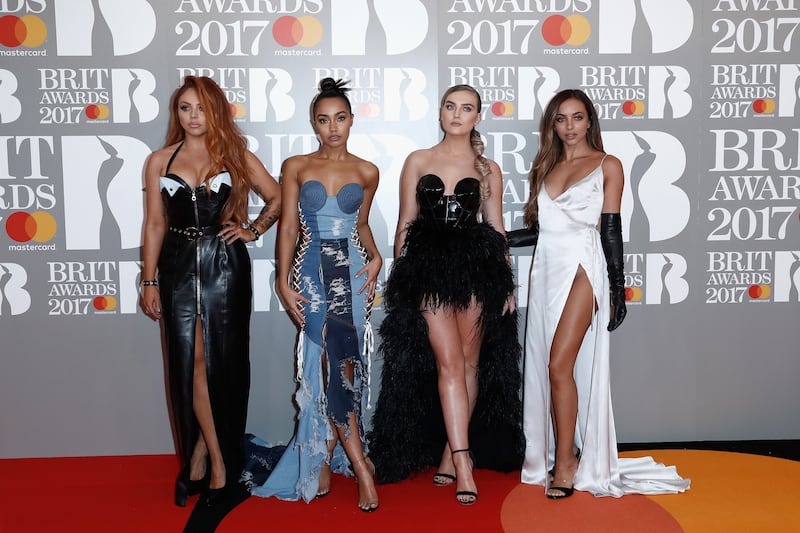 Jesy Nelson, in a black leather dress with white detail, with her Little Mix bandmates, attends The Brit Awards 2017 on February 22, 2017