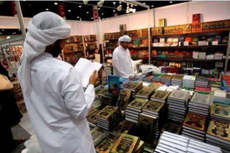 Men look at books displayed at the Abu Dhabi International Book Fair last year. Karim Sahib / AFP