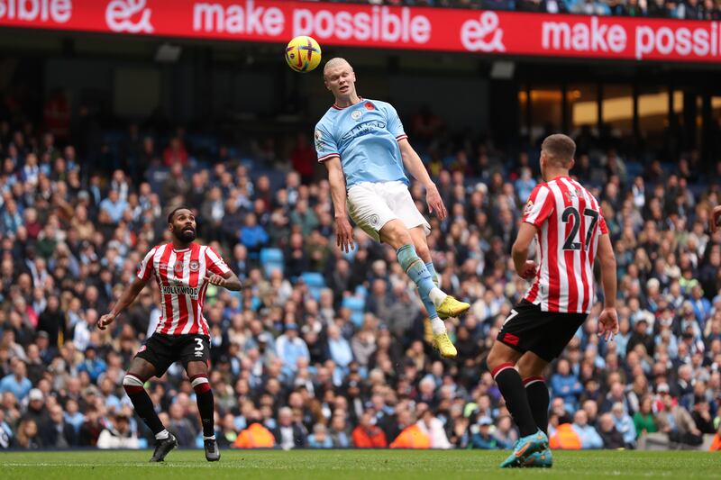 Erling Haaland leaps for a header. Getty