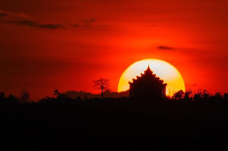 The sun sets over the Maha-ThaKyarYanThi Buddhist temple in Nyaypyitaw, Myanmar. Hein Htet / EPA / March 10, 2017