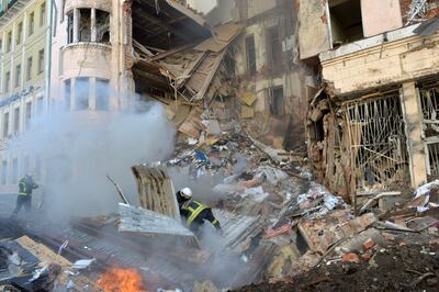 Firefighters at work on a building heavily damaged in a Russian rocket attack on Kharkiv, March 14. Photo: AFP