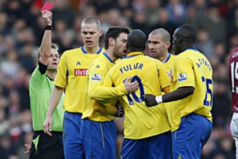 Ricardo Fuller, centre, is given his marching orders by the referee Michael Jones after he slapped his teammate Andy Griffin during Stoke's 2-1 defeat to West Ham.