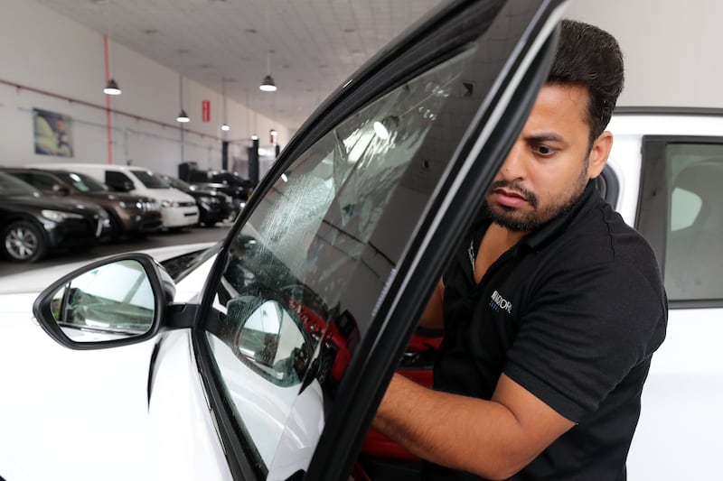 Mohammed Saidur fits window tints to provide an extra layer of protection against the sun.
