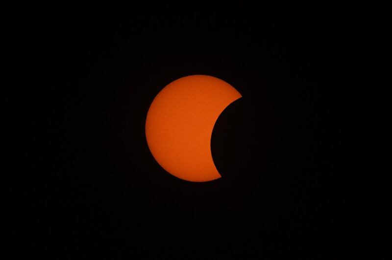 The moon starts to move in front of the sun in central Myanmar.  AFP