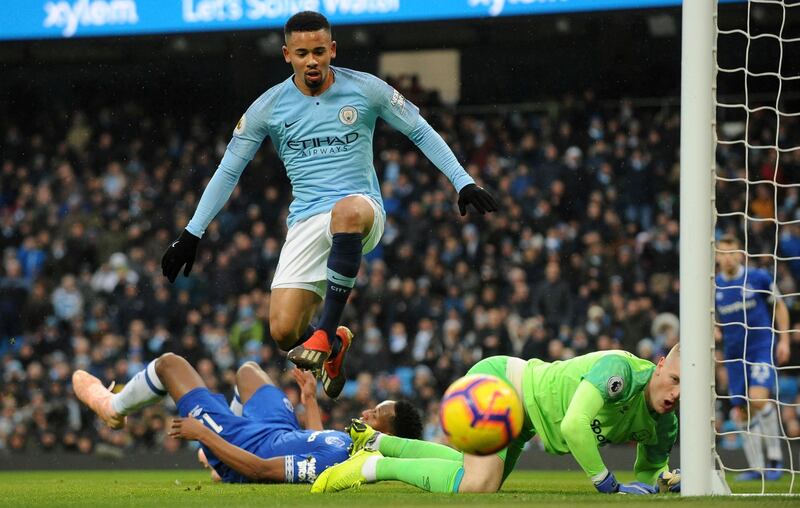 Manchester City's Jesus, center, jumps over Pickford. AP Photo