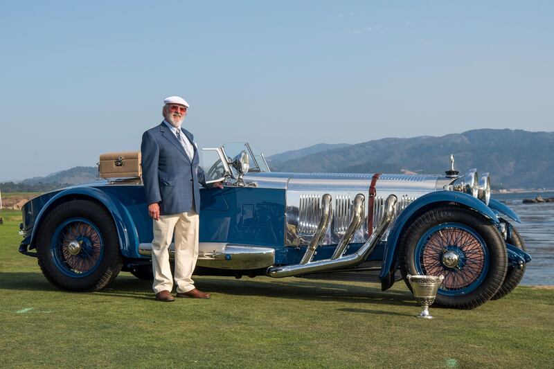 Bruce McCaw stands for a photograph next to his silver and blue 1929 Mercedes-Benz S Barker Tourer after winning the Best of Show award during the 2017 Pebble Beach Concours d'Elegance. David Paul Morris/Bloomberg