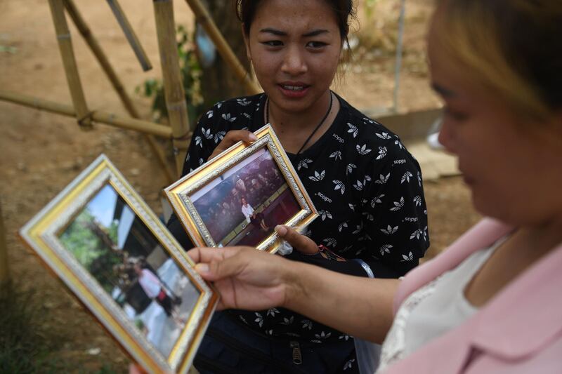 Vendors selling souvenir photos near the entrance of the Tham Luang cave. AFP