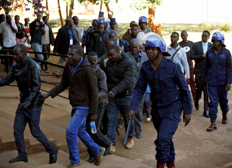 Some of the 16 people detained after police sealed off the building of Opposition Movement for Democratic Change (MDC) on Thursday, appear in court in the capital Harare, Zimbabwe, August 4, 2018. REUTERS/Philimon Bulawayo