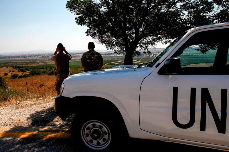 UN peacekeepers look out towards Syria from the Israeli-annexed Golan Heights on July 22, 2018.  / AFP / JALAA MAREY
