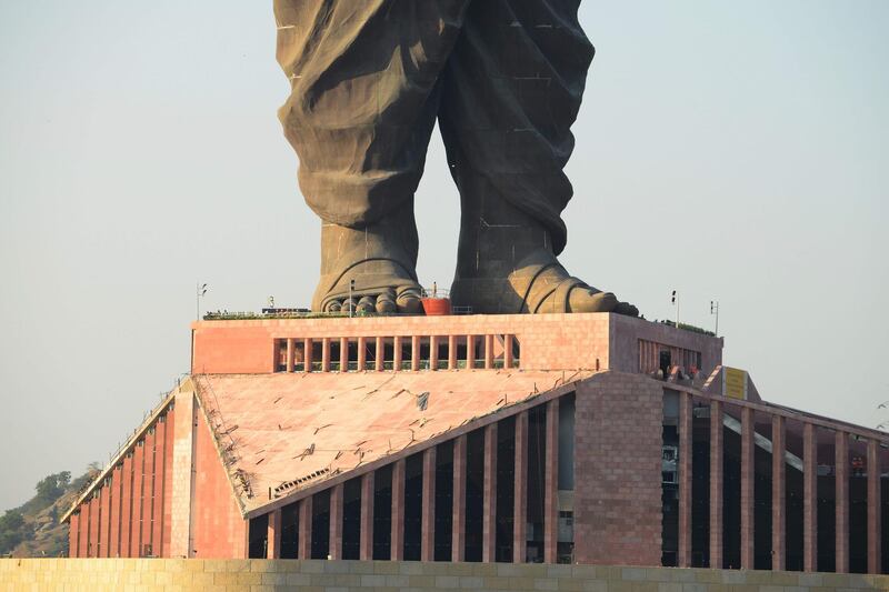 Indian construction workers are seen at the plinth structure the Statue Of Unity. AFP