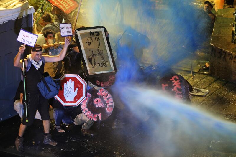 Israeli police use water canon against protesters during a protest against Israeli Prime Minister Benjamin Netanyahu. EPA