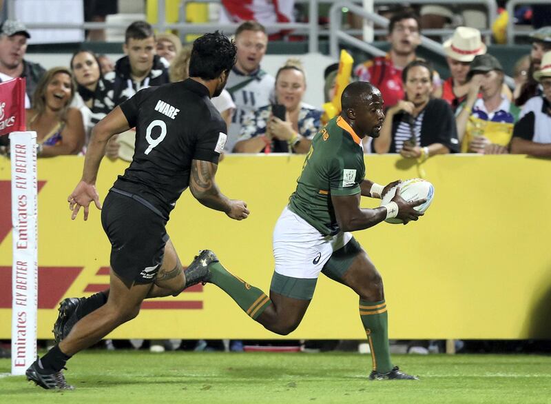 Dubai, United Arab Emirates - December 07, 2019: Siviwe Soyizwapi of South Africa scores during the game between New Zealand and South Africa in the mens final at the HSBC rugby sevens series 2020. Saturday, December 7th, 2019. The Sevens, Dubai. Chris Whiteoak / The National
