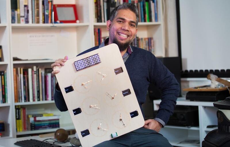British inventor Zahid Ali with a prototype of his smartclock. Photo by Shawn Ryan