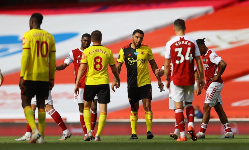 Watford captain Troy Deeney, centre, with teammates and Arsenal players after Watford's relegation from the Premier League. Reuters