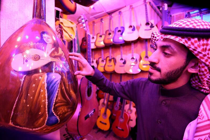 A Saudi musician looks at the design of oud instruments in a music shop at the Hilla market, in Riyadh, Saudi Arabia January 20, 2020. Reuters