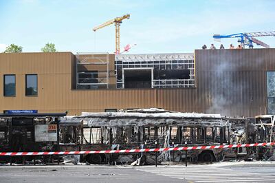Burnt buses in front of the future Paris 2024 Olympic swimming venue, in Aubervilliers, north of Paris following riots. AFP