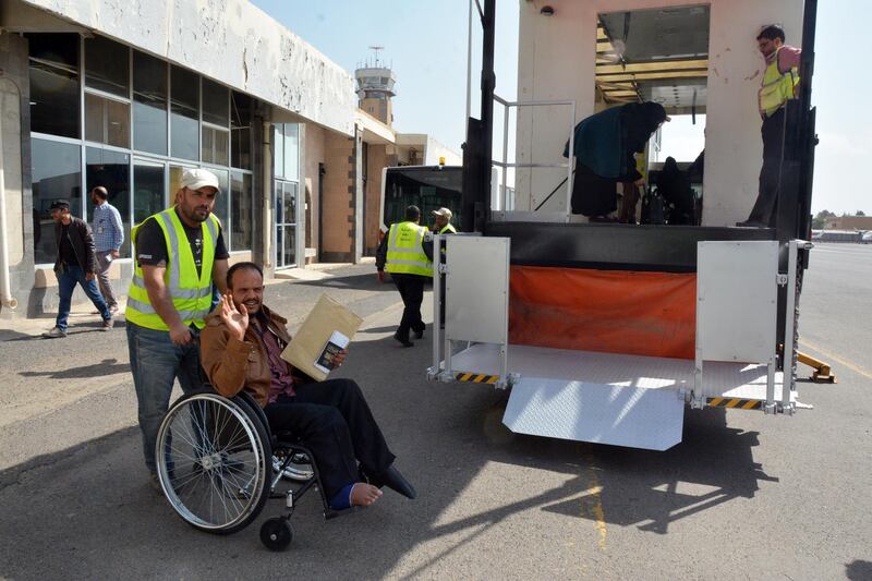 An airport worker pushes a sick Yemeni in a wheelchair before boarding a UN medical evacuation plane at Sana'a airport, Yemen.  EPA