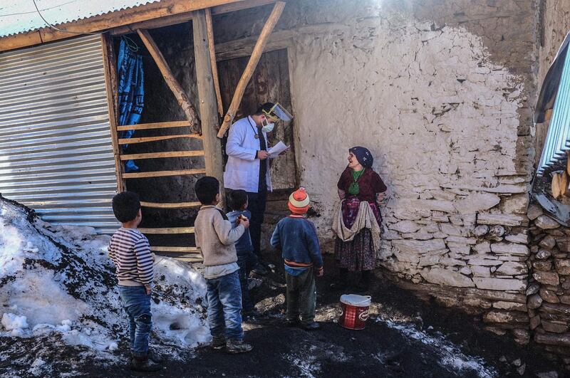 Doctor Akay Kaya from Bahcesaray public hospital vaccination team speaks with a Kurdish woman in the village of Guneyyamac in eastern Turkey. AFP