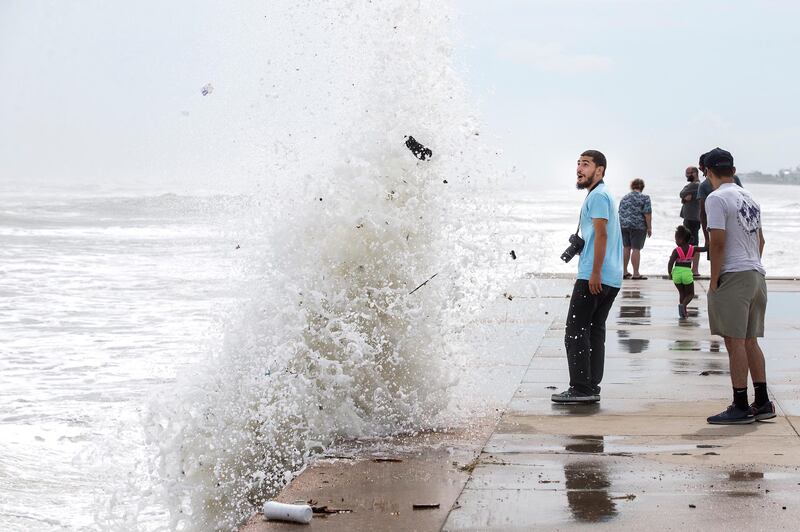 A wave stirred up by the approach of Hurricane Laura crashes up and over the seawall in Galveston, Texas. AP Photo