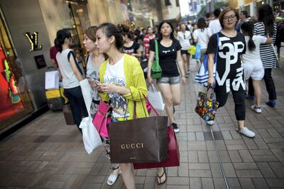 Tourists walk through a shopping area in Tsim Sha Tsui of Hong Kong, China, on Tuesday, Oct. 2, 2012. Photographer: Lam Yik Fei/Bloomberg