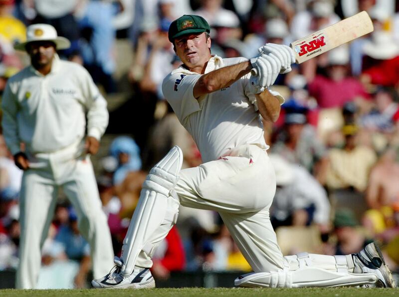 India's Virender Sehwag (L) looks on as Australia's captain Steve Waugh (R) hits a boundry during the third day of the fourth test against India at the Sydney Cricket Ground January 4, 2004. Waugh is retiring at the end of the test match. Australia are six wickets for 342 runs at stumps, after India declared at 705 runs for seven wickets in their first innings, with Tendulkar not out on 241 runs. REUTERS/David Gray  DG
Reuters / Picture supplied by Action Images *** Local Caption *** RBBORH2004010400093.jpg