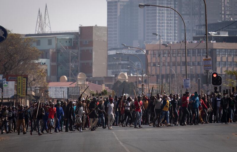 Supporters of Mr Zuma march through downtown Johannesburg. Mr Zuma also faces a corruption case relating to a $2 billion arms deal in 1999 when he was deputy president. He denies all charges levelled against him.