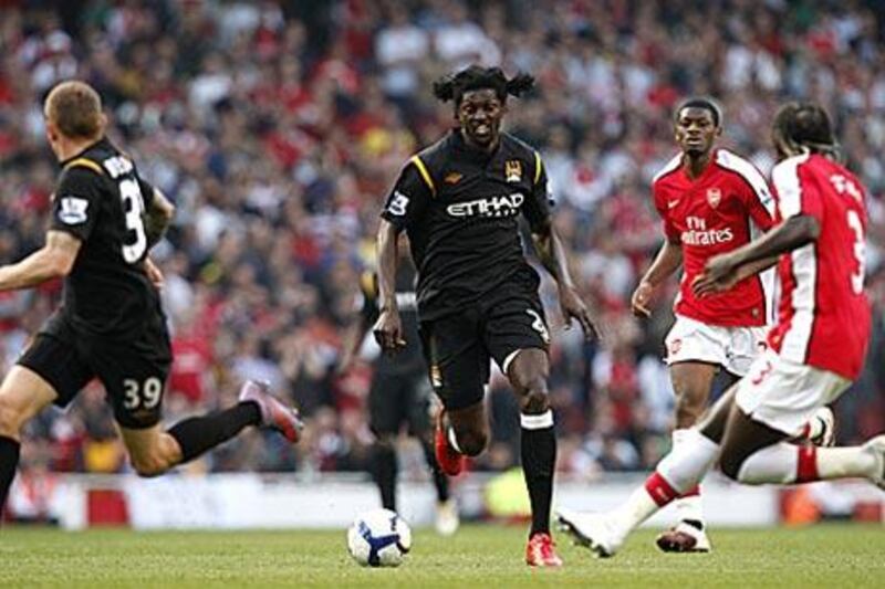 Emmanuel Adebayor runs at the Arsenal defence.