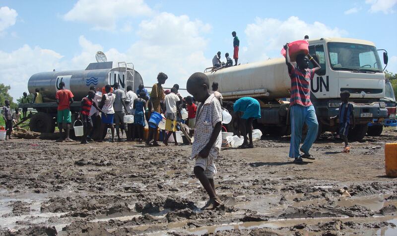 People gather to receive water rations at a UN compound in South Sudan. AFP