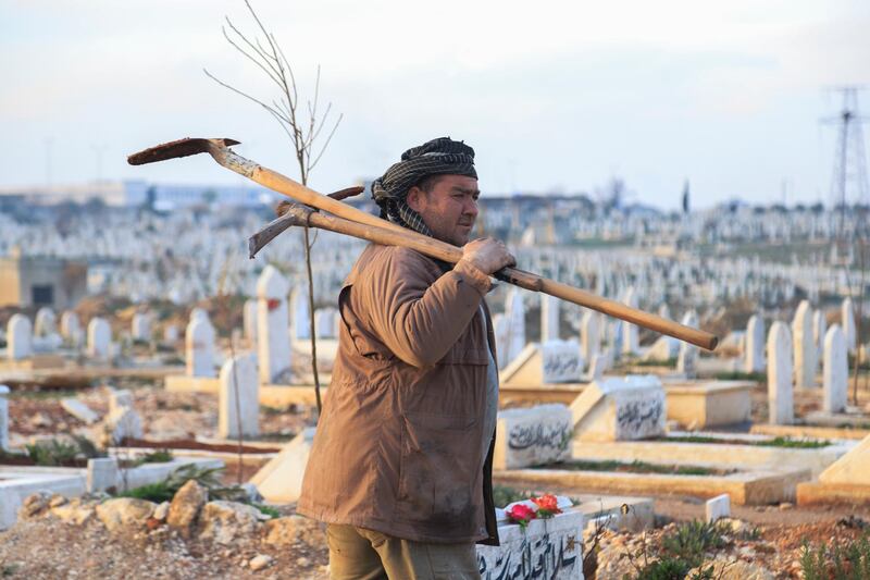 Abdul Mohsen Latif is a gravedigger in one of Idlib’s cemeteries. "I never imagined that I would bury so many people,” he said. Abd Almajed Alkarh for The National.