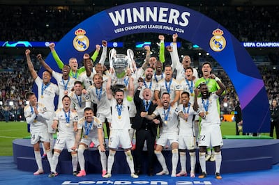 Real Madrid's players and manager Carlo Ancelotti celebrate with the trophy after winning the final. AP